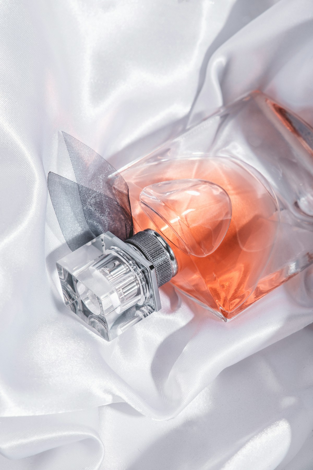 Elegant navulbaar parfumflesje op wit satijn